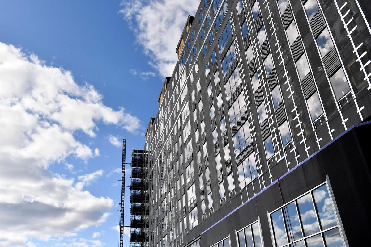 Clouds are reflected in the windows of the Here: State College construction site on Beaver Avenue on Wednesday, April 1, 2020. Construction is currently on hold due to the coronavirus.