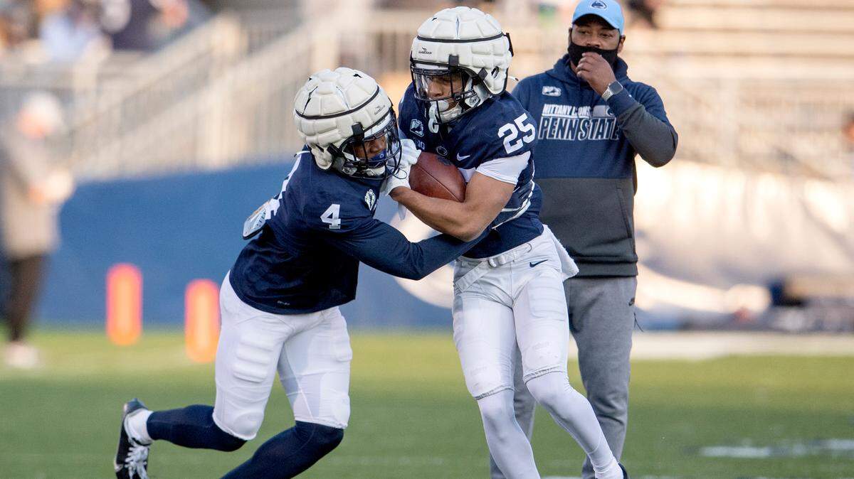 Penn State cornerbacks Kalen King and Daequan Hardy run a drill during football practice as cornberbacks coach Terry Smith watches on Friday, April 23, 2021 at Beaver Stadium.