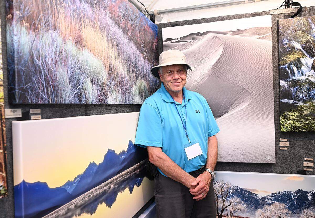 Bill Schafer of Moments in Time stands by his art work at the 57th Central Pennsylvania Festival of the Arts in State College Thursday, July 13, 2023.