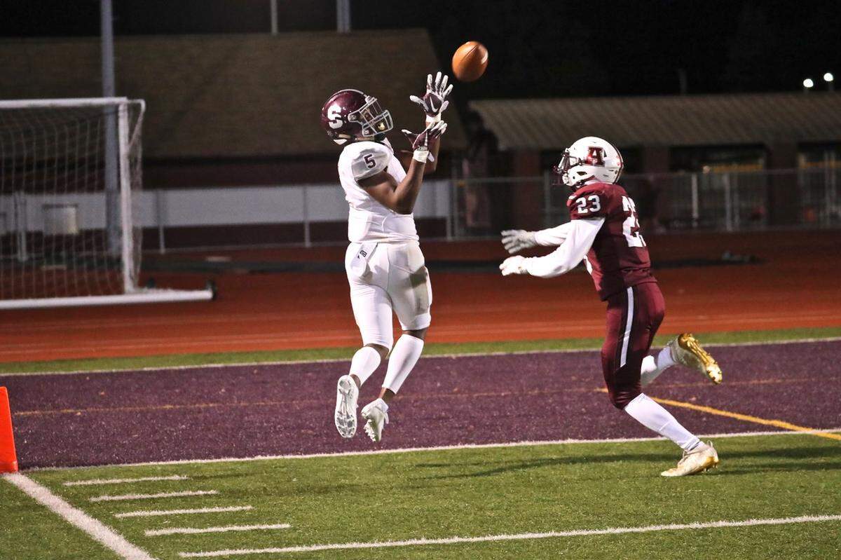 State College’s Isaiah Edwards catches a touchdown pass from QB Brady Dorner against Altoona Friday night. State College won 48-0.