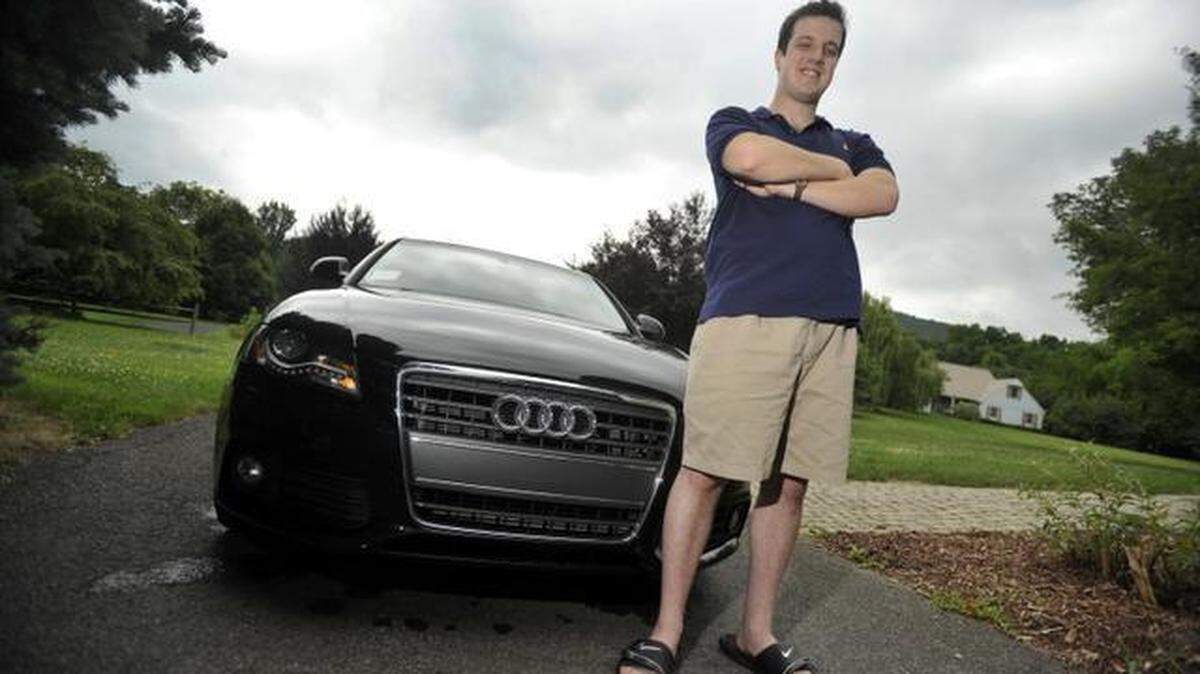 Zachary Gruneberg stands beside the Audi he bought with some of his more than $500,000 in poker winnings at his home in Boalsburg on Monday.
