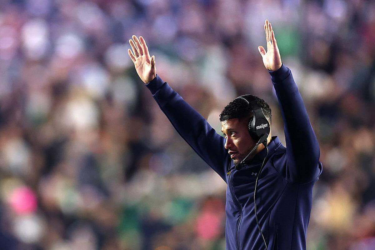 CHESTNUT HILL, MASSACHUSETTS - NOVEMBER 01: Notre Dame Fighting Irish head coach Marcus Freeman celebrates from the sideline during the second half of the game against the Boston College Eagles at Alumni Stadium on November 01, 2025 in Chestnut Hill, Massachusetts. The Fighting Irish defeat the Eagles 25-10.  (Photo by Maddie Meyer/Getty Images)