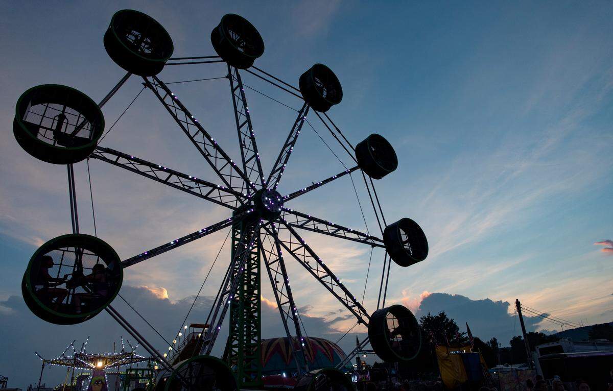 The sun sets over the Bartlebaugh Amusements rides at the  Centre County Grange Fair on Thursday, Aug. 26, 2021.  