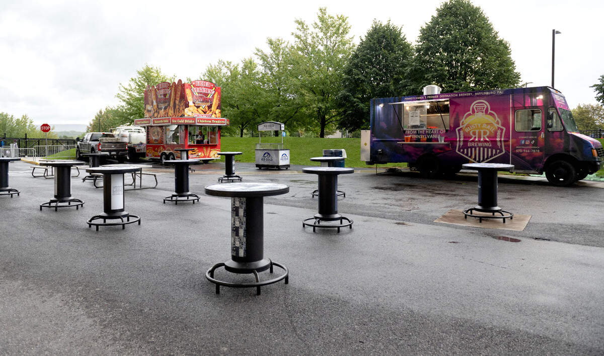 The open-air Gate F lounge area at Beaver Stadium features local food trucks, tables and a large screen TV before the game against Bowling Green on Saturday, Sept. 7, 2024.
