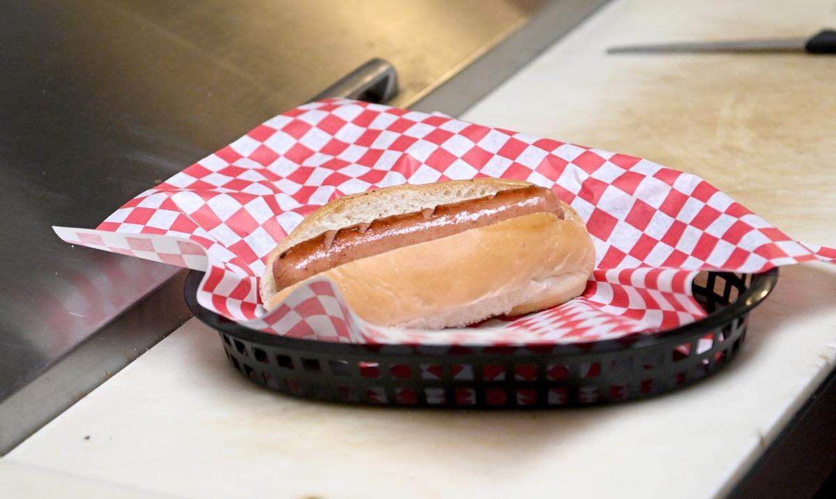 A hot dog waits to get toppings at Twin Kiss on Friday, May 19, 2023.