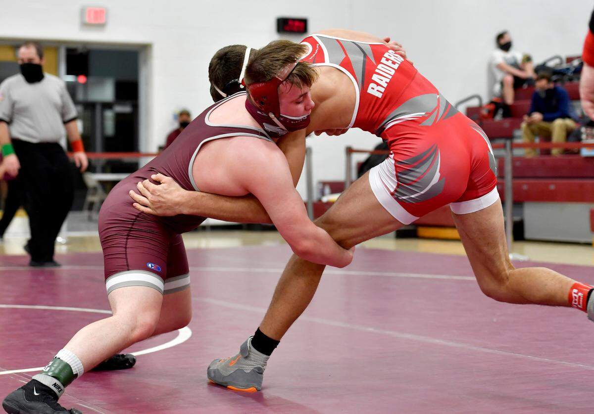 State College’s Carson Manville reaches for Bellefonte’s Ethan Rossman in the 189 lb championship bout at the District 6 3A tournament on Friday, Feb. 19, 2021 at Altoona High School.