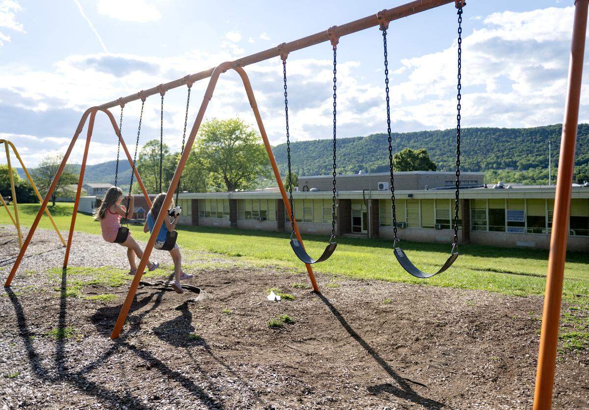 Kids enjoy the swings behind the Benner Elementary School during the farewell celebration on Monday, June 1, 2026.