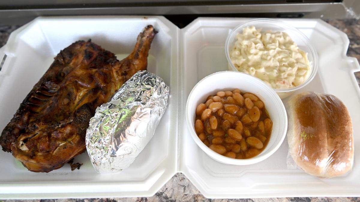 A chicken meal including a baked potato, macaroni salad, baked beans and a roll at The Country Kitchen and Dutch Valley Bakery on Friday, May 12, 2023.