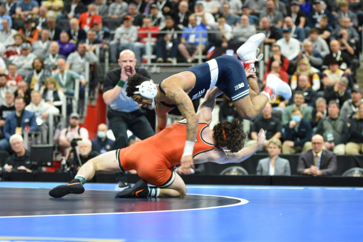 Penn State’s Roman Bravo-Young leaps over Oklahoma State’s Daton Fix to avoid being taken down in their 133-pound finals match of the NCAA Championships on Saturday, March 19, 2022 at Little Caesars Arena in Detroit. Bravo-Young edged Fix, 3-2, for his second straight title.
