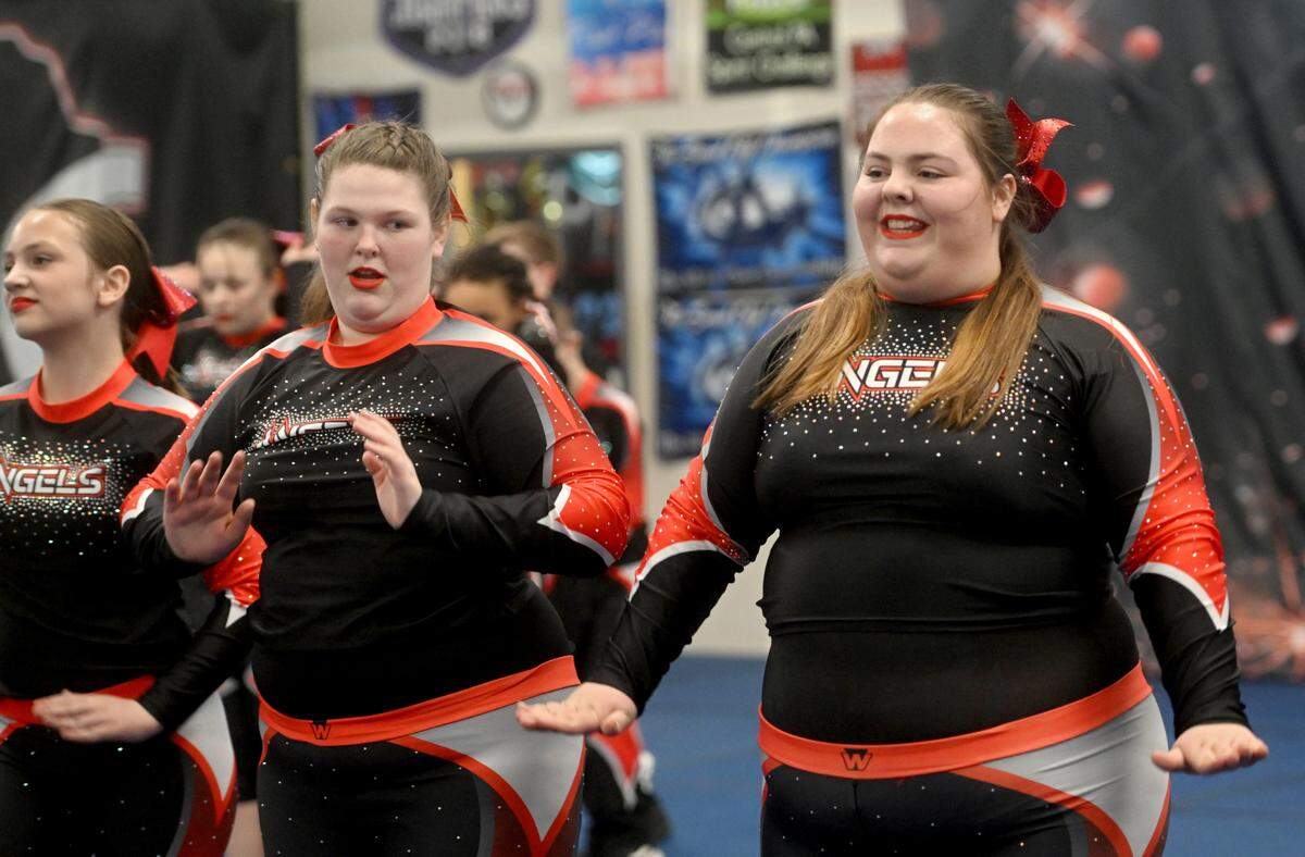 Fame Angels teammates Emily Wolfe and Kryslynn Rock smile as they practice their routine on Tuesday, March 12, 2024.
