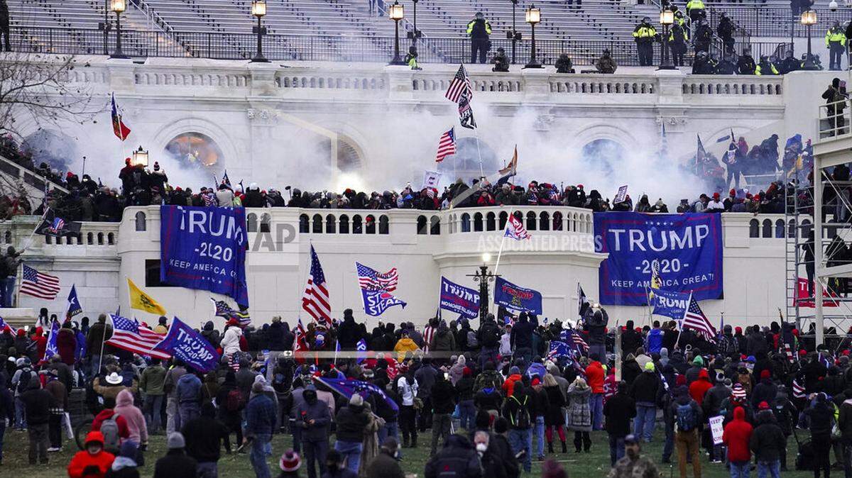 FILE - Violent insurrectionists loyal to President Donald Trump storm the Capitol, Jan. 6, 2021, in Washington. Matthew Carver, of Vanceburg, Ky., has been charged in connection to the riot. (AP Photo/John Minchillo, File)