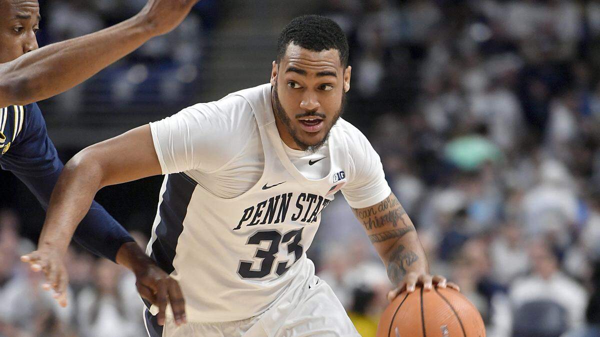 Penn State's Shep Garner dribbles around a Michigan defender during the game on Wednesday, February 21, 2018 at the Bryce Jordan Center.