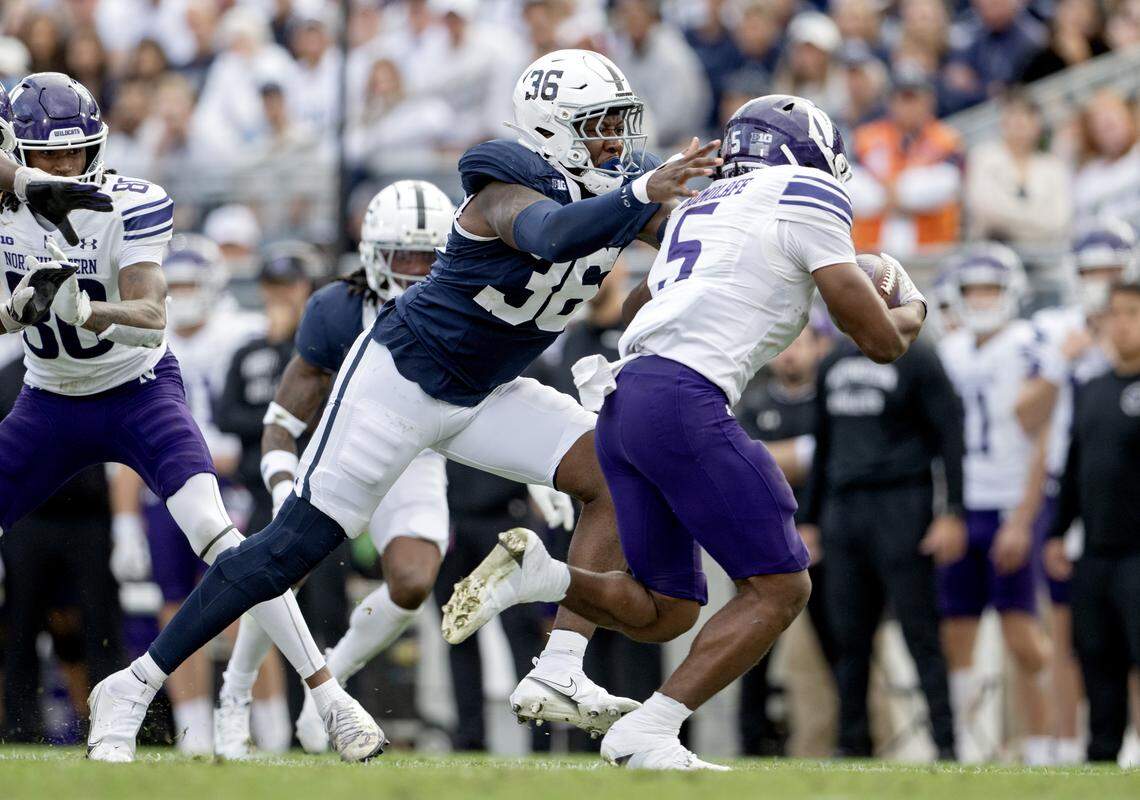 Penn State linebacker Zuriah Fisher reaches for Northwestern’s Caleb Komolafe during the game on Saturday, Oct. 11, 2025.