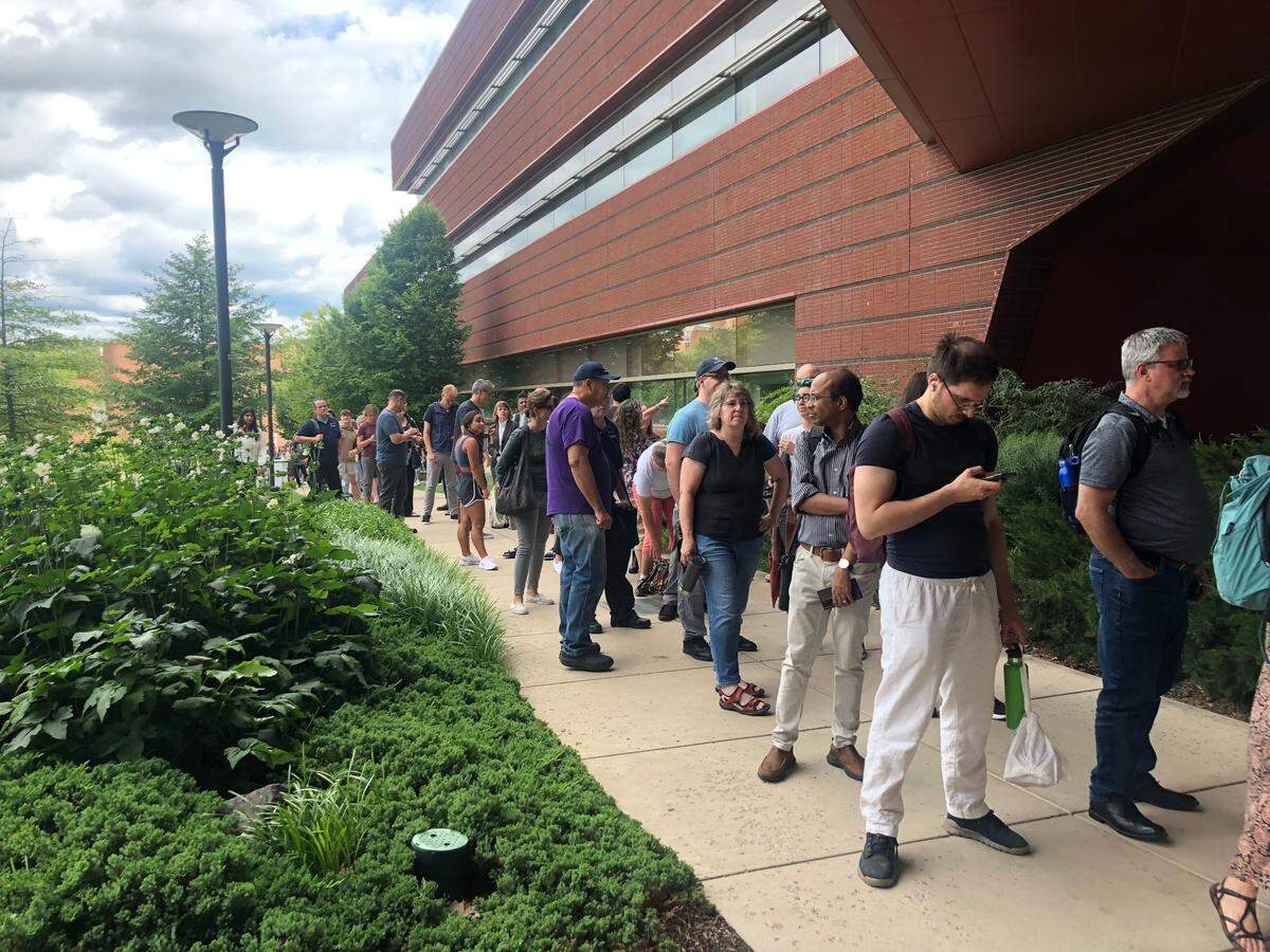 More than 100 people are lined up near the Millennium Science Complex on Wednesday afternoon as they wait to get their vehicles out of the Eisenhower Parking Deck. The parking structure was evacuated and closed due to a sinkhole.