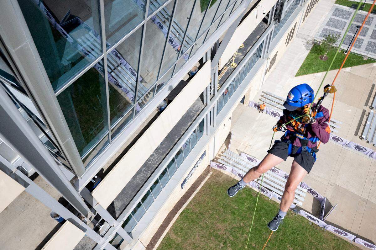 Dean Faye Chadwell, chair of the 2024 Penn State United Way campaign, goes Over the Edge at Beaver Stadium to support the Centre County United Way on Monday.