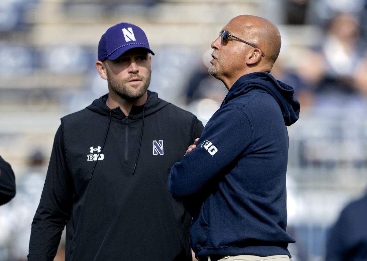 Penn State football coach James Franklin and Northwestern coach David Braun talk as their teams warm up for the game on Saturday, Oct. 11, 2025.