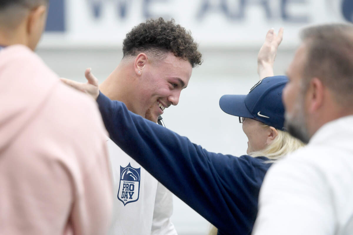 Tight end Theo Johnson gets hugs from family after showing off his skills for NFL scouts at Penn State’s Pro Day on Friday, March 15, 2024 in Holuba Hall.