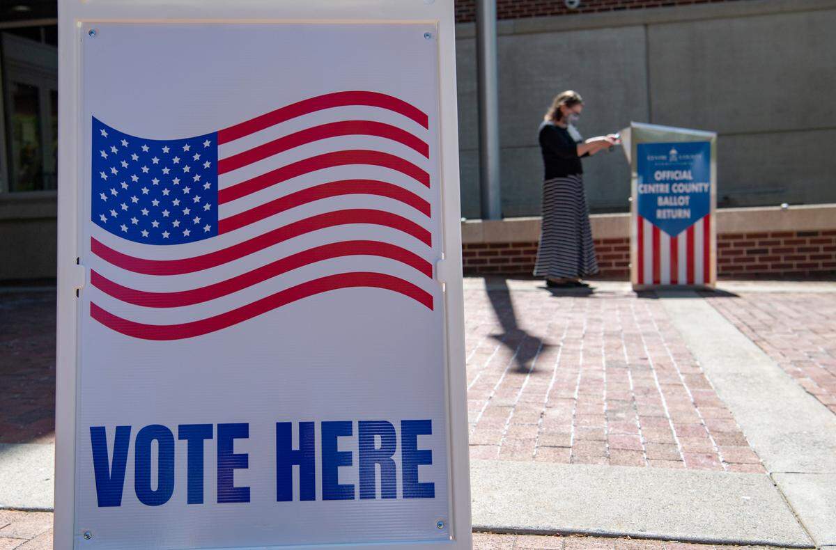 A voter places their ballot in the dropbox outside of the State College borough building for the May 2021 primary election.