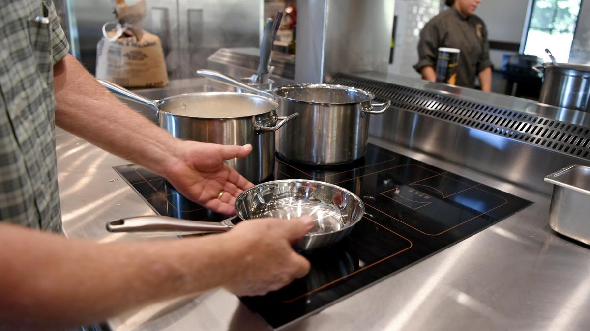 RE Farm Cafe’s Duke Gastiger talks about the custom built induction kitchen on Monday, July 16, 2019.