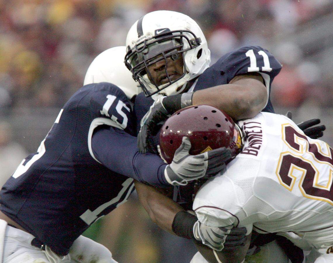 Penn State’s Navorro Bowman and Bani Gbadyu take down Minnesota’s Duane Bennett at Beaver Stadium on Saturday, Oct. 17, 2009.