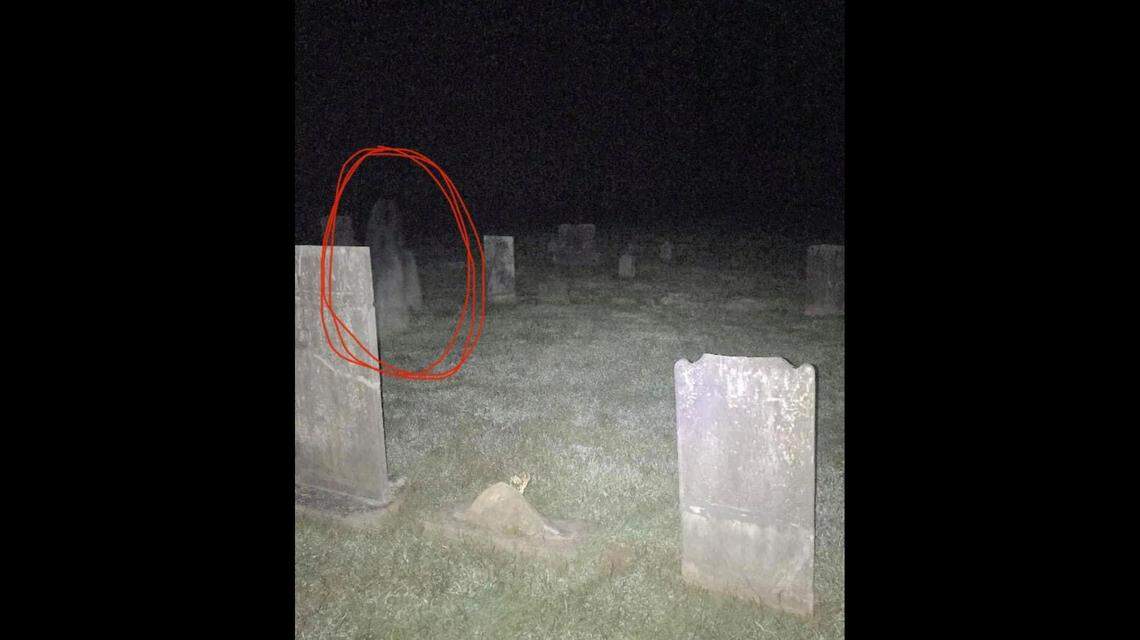 “It very clearly takes the shape of a person,” Tyler Karanasios says of the image he spotted in the cemetery photo.