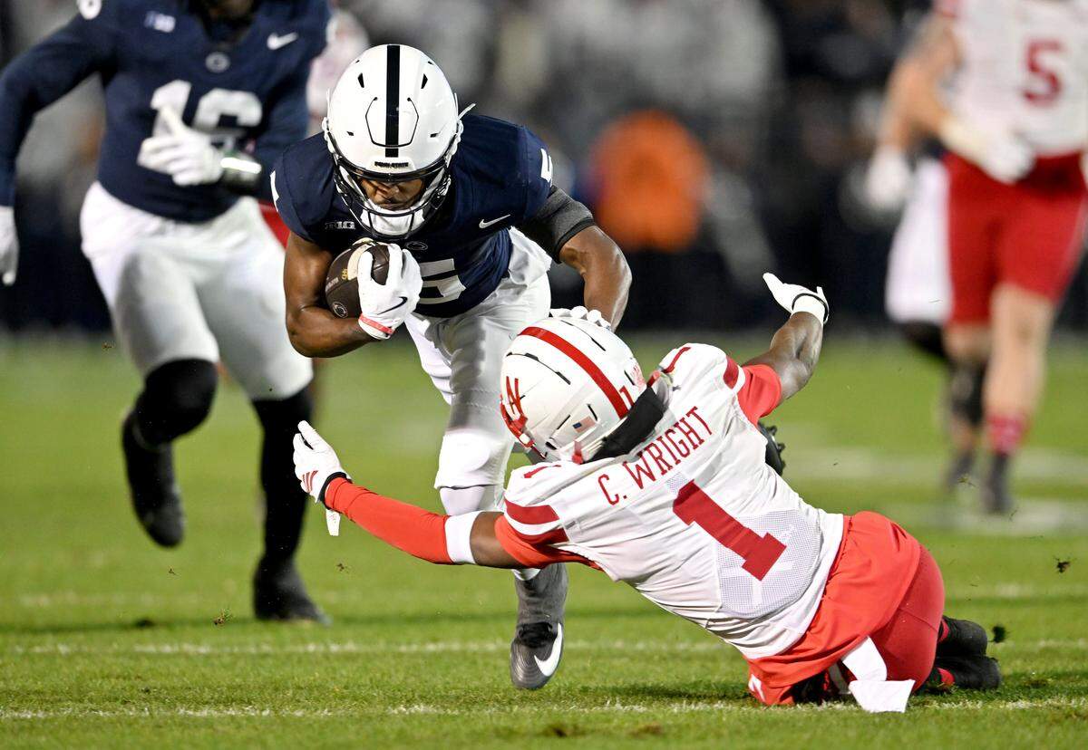Nebraska defensive back Ceyair Wright reaches for Penn State wide receiver Devonte Ross during the game on Saturday, Nov. 22, 2025 at Beaver Stadium.