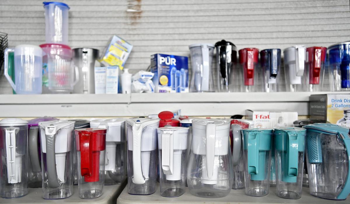 A table full of water pitchers at the Trash to Treasure sale at Beaver Stadium.