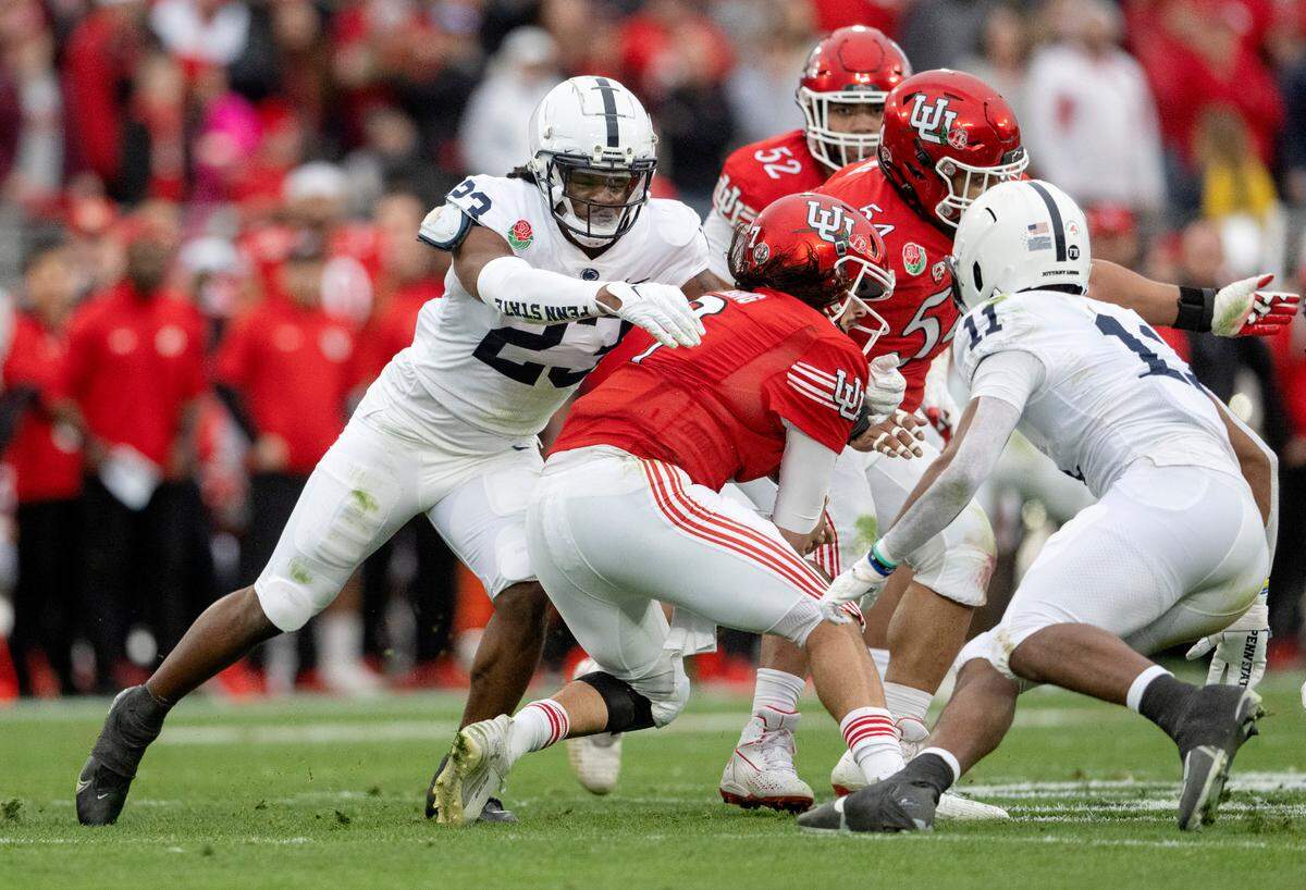 Penn State linebacker Curtis Jacobs stops Utah quarterback Cam Rising during the Rose Bowl game on Monday, Jan. 2, 2023.