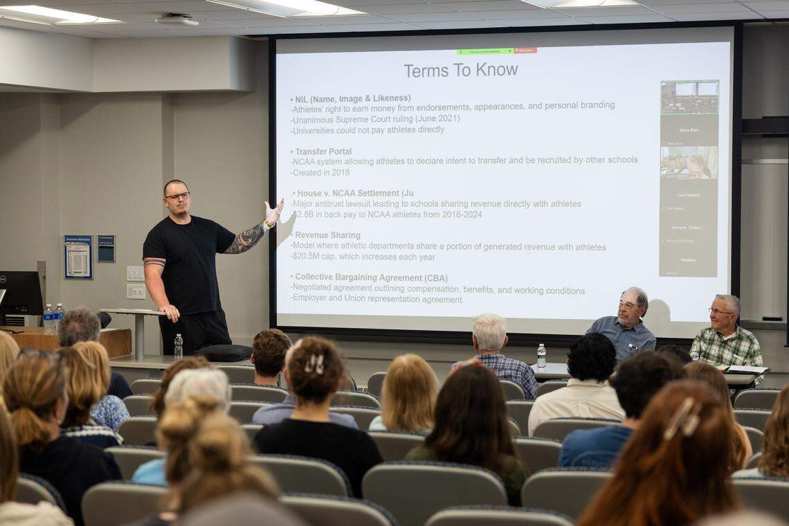 Moderator Landon Tengwall speaks to the crowd during a debate over whether college athletes should be paid in University Park, Pa., on Thursday, April 16, 2026. Tengwall hosts “The Landon Tengwall Show” on YouTube.