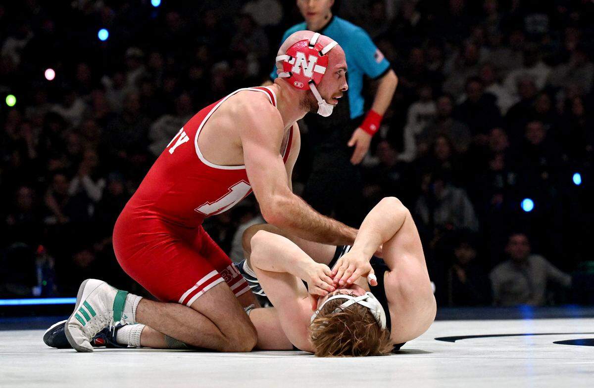 Nebraska’s Brock Hardy pats Penn State’s Braeden Davis on the stomach after getting a pin in the 141 lb bout of the match on Friday, Jan. 30, 2026.