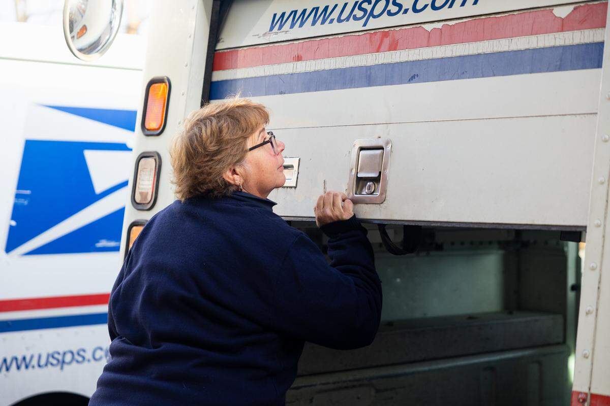 USPS mail carrier Colleen Sweeney opens up her trunk as she prepares for her route on Tuesday, Jan. 13, 2026 in State College. Sweeney has been recognized for traveling around a million miles while working as a USPS mail carrier over the course of 30 years.