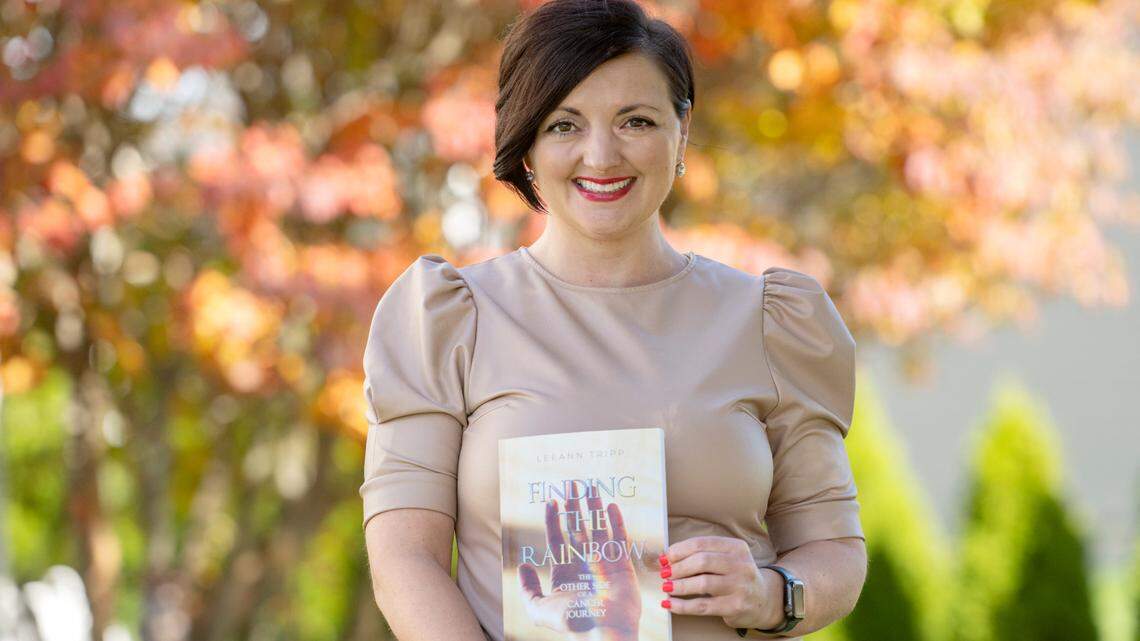 LeeAnn Tripp holds her book “Finding the Rainbow” on Thursday, Oct. 26, 2023.