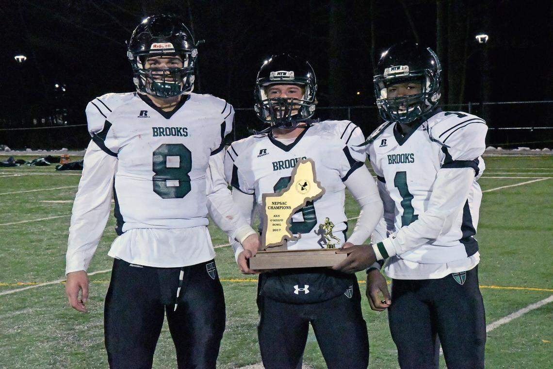 Penn State tight end Pat Freiermuth poses with Brooks School teammates Seamus Lambert (9) and Terrell Brown (1) after the program’s 2017 bowl win over New Hampton.