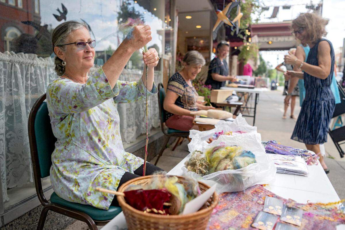 Ann Seltzer Panghorn spins art yarn with a drop spindle outside of Art a la Carte a part of Friday in the ‘Fonte on Friday, July 29, 2022.