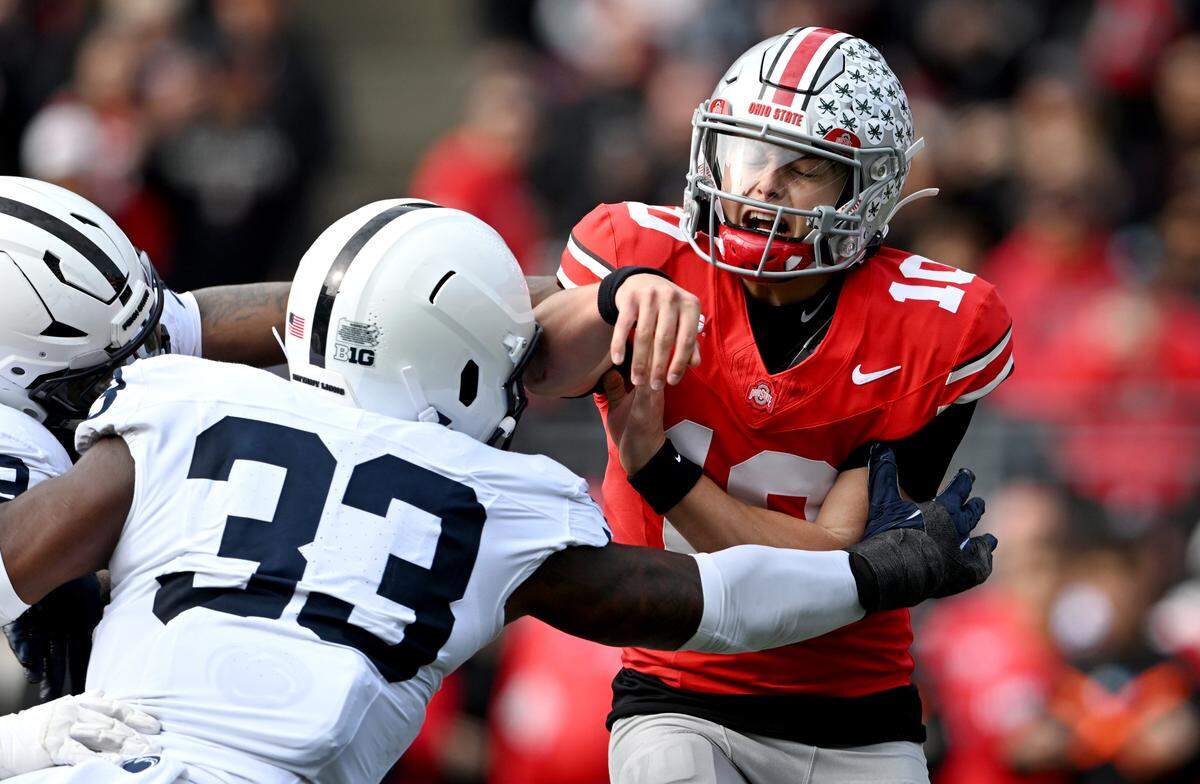 Ohio State quarterback Julian Sayin gets a throw off before being hit by Penn State defensive end Dani Dennis-Sutton during the game on Saturday, Nov. 1, 2025.
