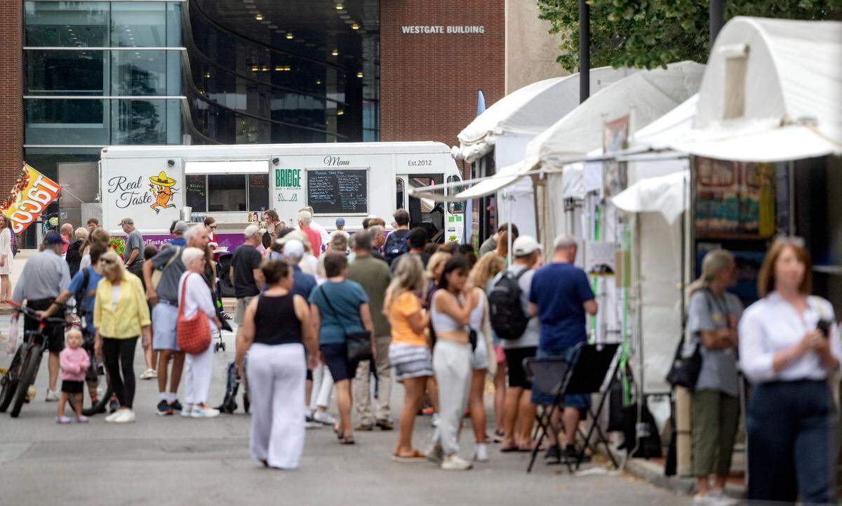 Real Taste food truck among the artist booth on Pollock Road at Central Pennsylvania Festival of the Arts on Thursday, July 11, 2024.