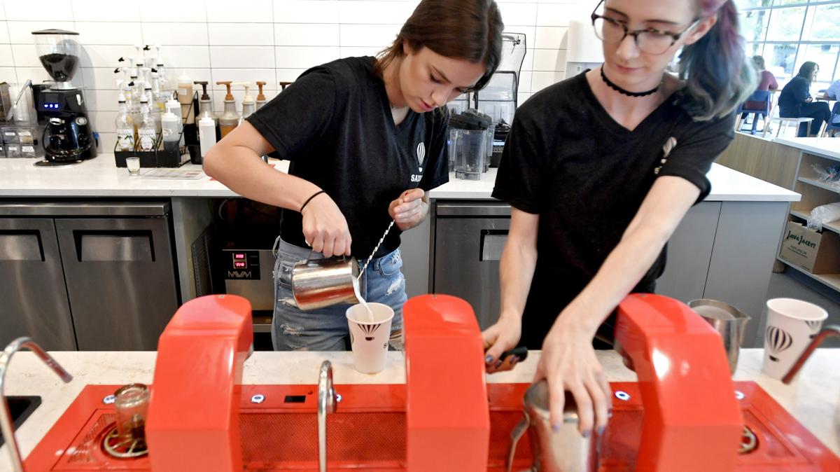 Marley Gordon makes a cappuccino alongside another barista at Saxbys in the Business Building on the Penn State campus on Tuesday, Sept. 18, 2018.