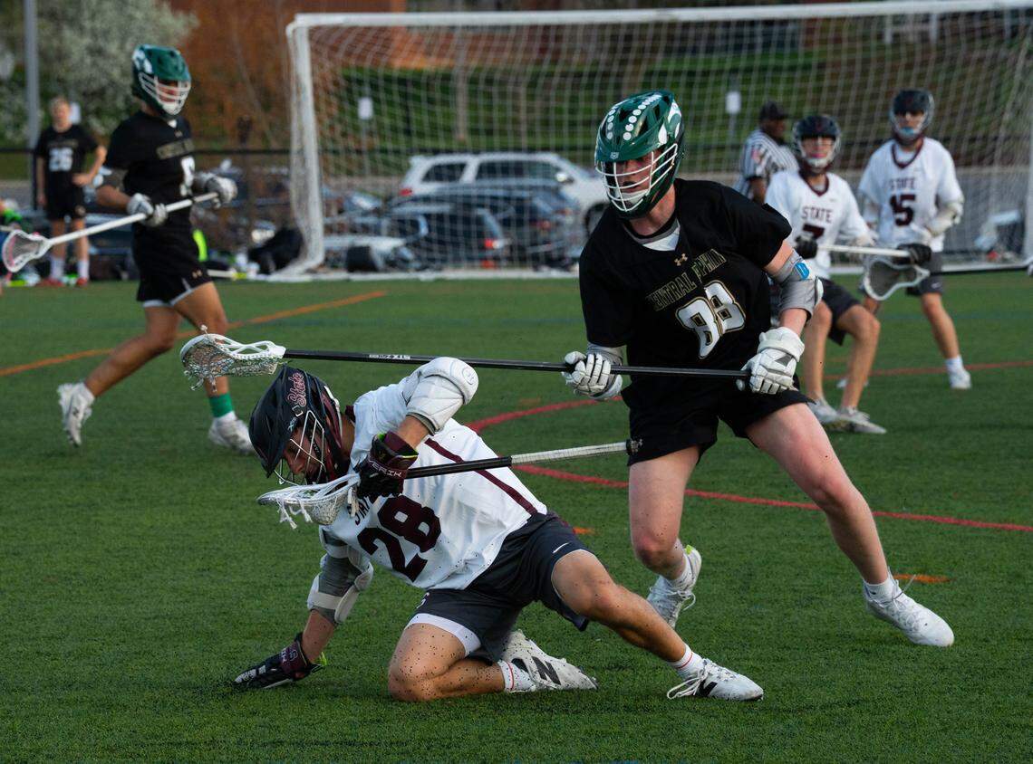 State High’s Trey Combs (28) evades a defender while carrying the ball during a lacrosse game against Central Dauphin in State College, Pa., on Monday, April 13, 2026. The Little Lions defeated the Rams 17-7.