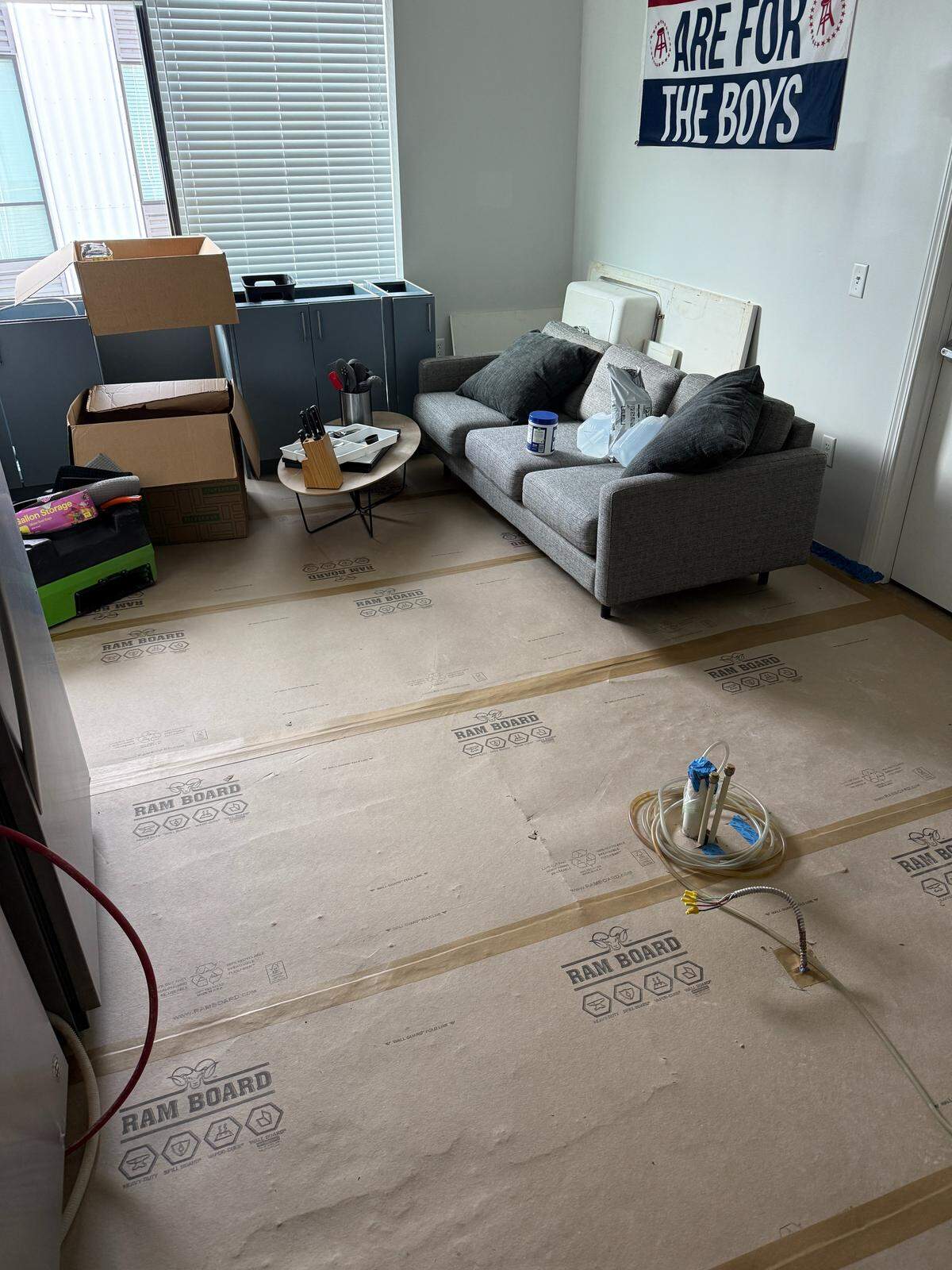 The kitchen cabinets and sink were removed from the kitchen and placed in the living room of an apartment on the 12th floor of The Maxxen in downtown State College. The apartment was without a working kitchen or kitchen water for days while maintenance tried to dry out the apartment floors after a pipe burst in early February, flooding the apartment. This photo was taken on March 18.