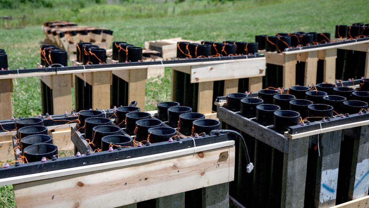 Racks of fireworks that have been placed and wired to the rail which will get plugged into a module that will be controlled by a computer on the night of the show.