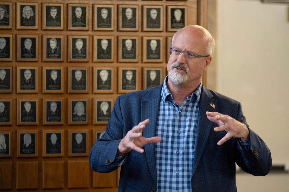 Centre County Commissioner Mark Higgins speaks Monday at a press conference at the College Avenue Satellite Elections Office.