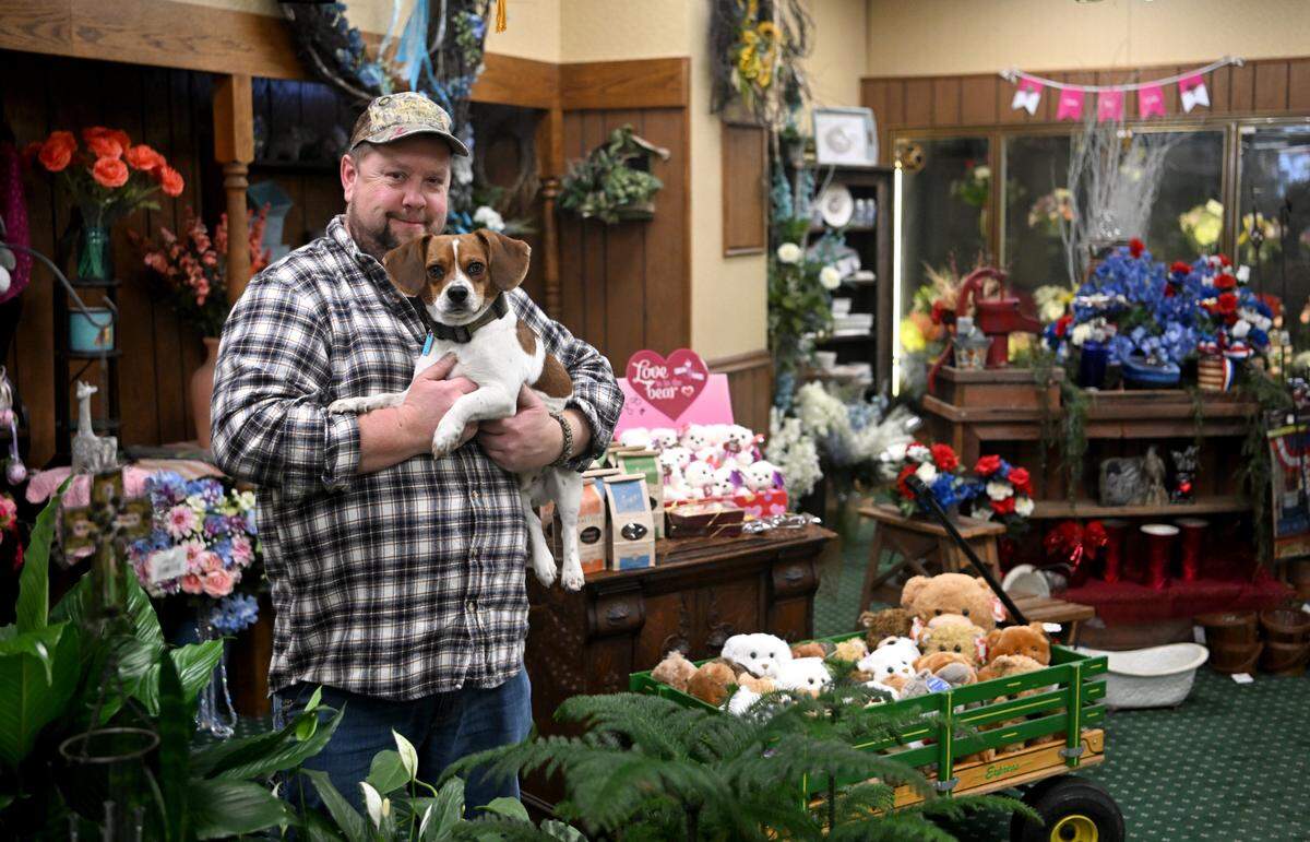 Dave Woodring and his dog Ruger pose for a photo in Woodring’s Floral Gardens on Tuesday, Feb. 21, 2023.