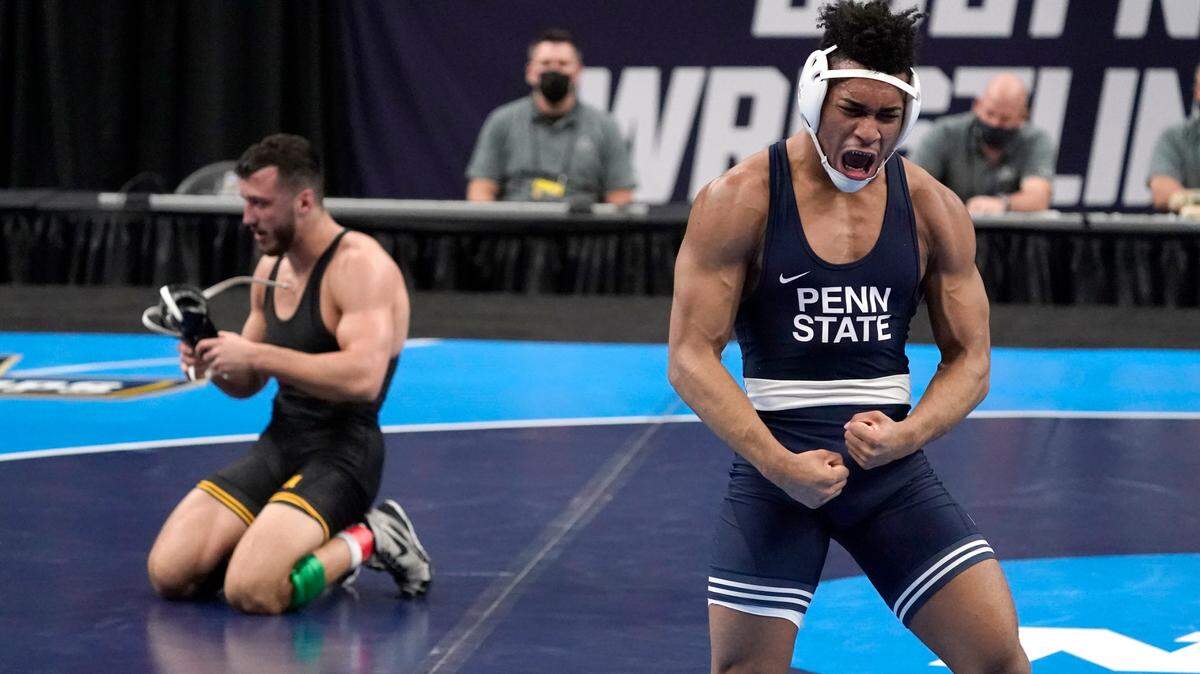 Penn State’s Carter Starocci, right, celebrates after defeating Iowa’s Michael Kemerer during their 174-pound match in the finals of the NCAA wrestling championships Saturday, March 20, 2021, in St. Louis.