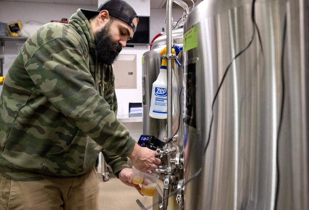 Paulo Nami, the head brewer at Antifgragile Brewery, tests the carbonation of a beer on Tuesday, Nov. 28, 2023.