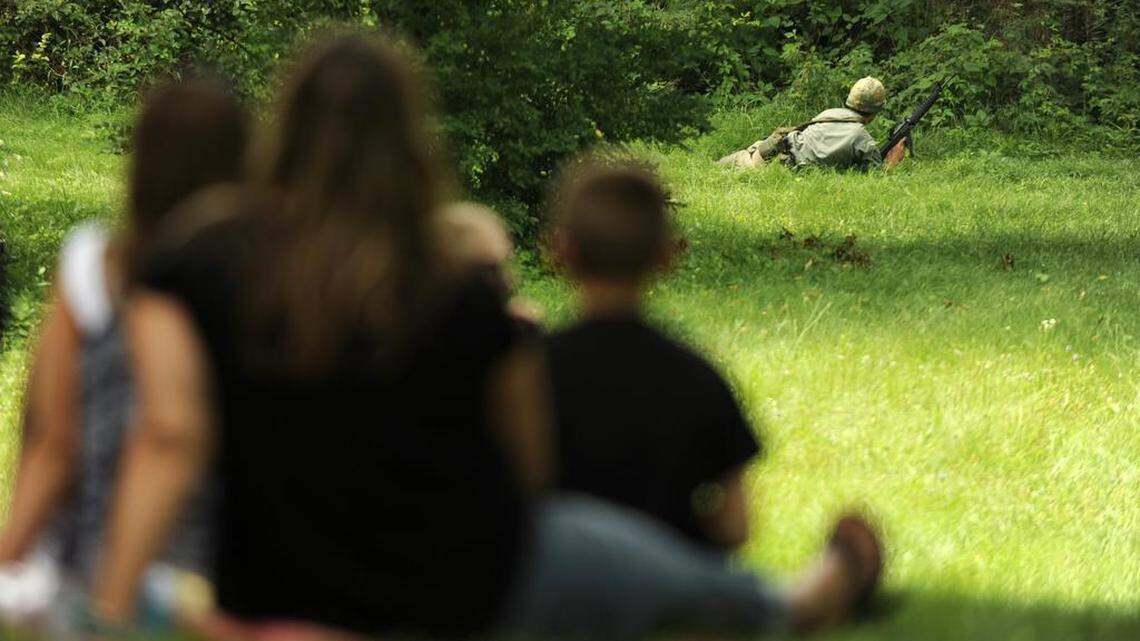 A family watches a reenactment during Vietnam Revisited at the Pennsylvania Military Museum on Sunday, July 19, 2015.

