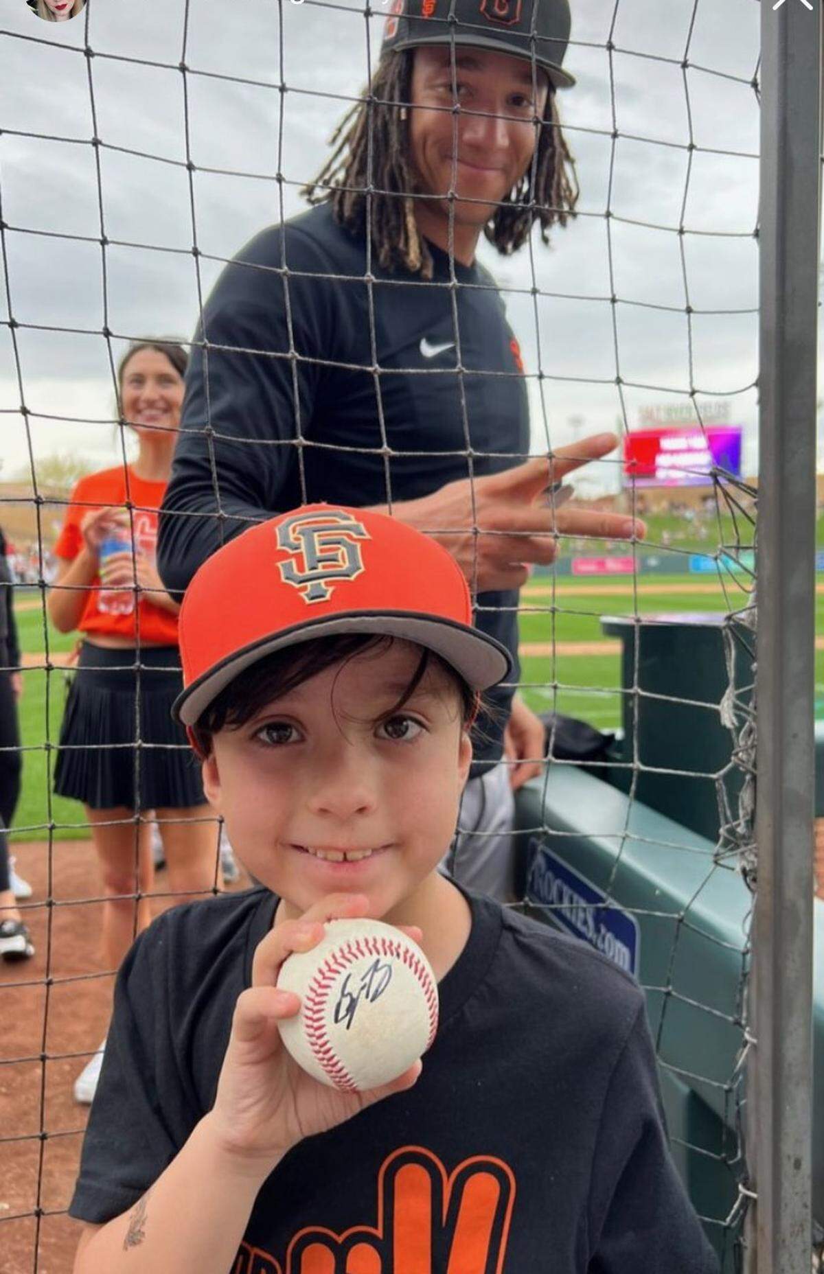 Spencer Bivens poses with a young fan after giving an autograph during spring training in 2023.