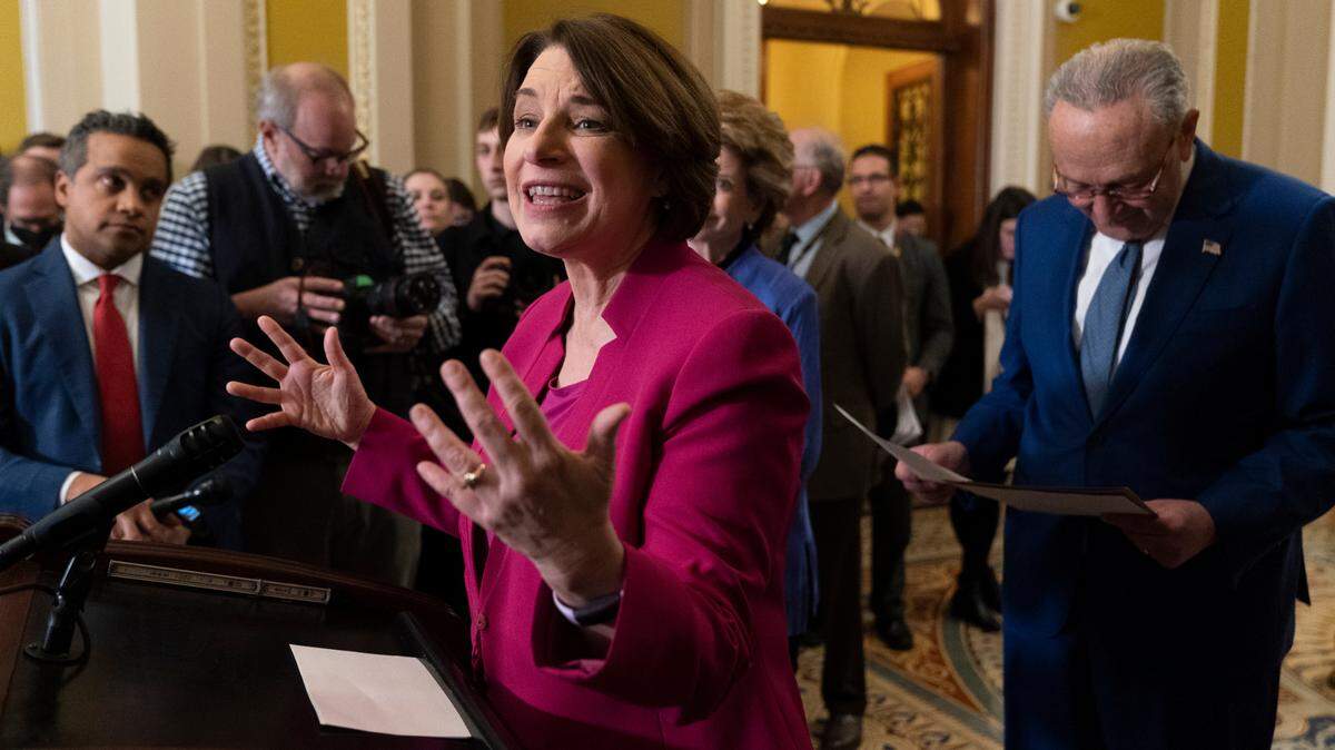 Sen. Amy Klobuchar, D-Minn., with Senate Majority Leader Chuck Schumer of New York, speaks during a news conference Tuesday after a Democratic Party policy luncheon meeting on Capitol Hill.