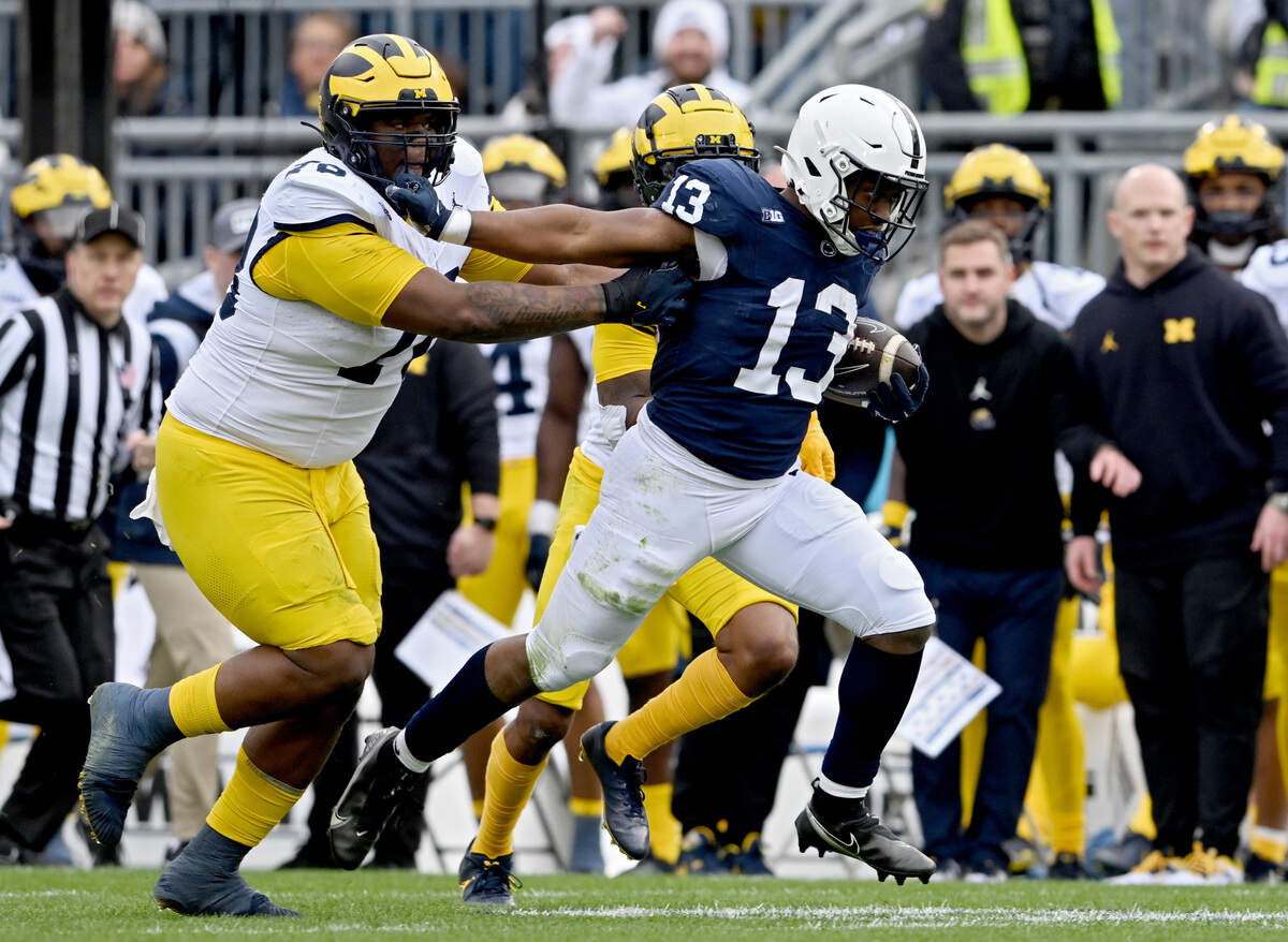 Penn State running back Kaytron Allen pushes past Michigan defenders during the game on Saturday, Nov. 11, 2023.  