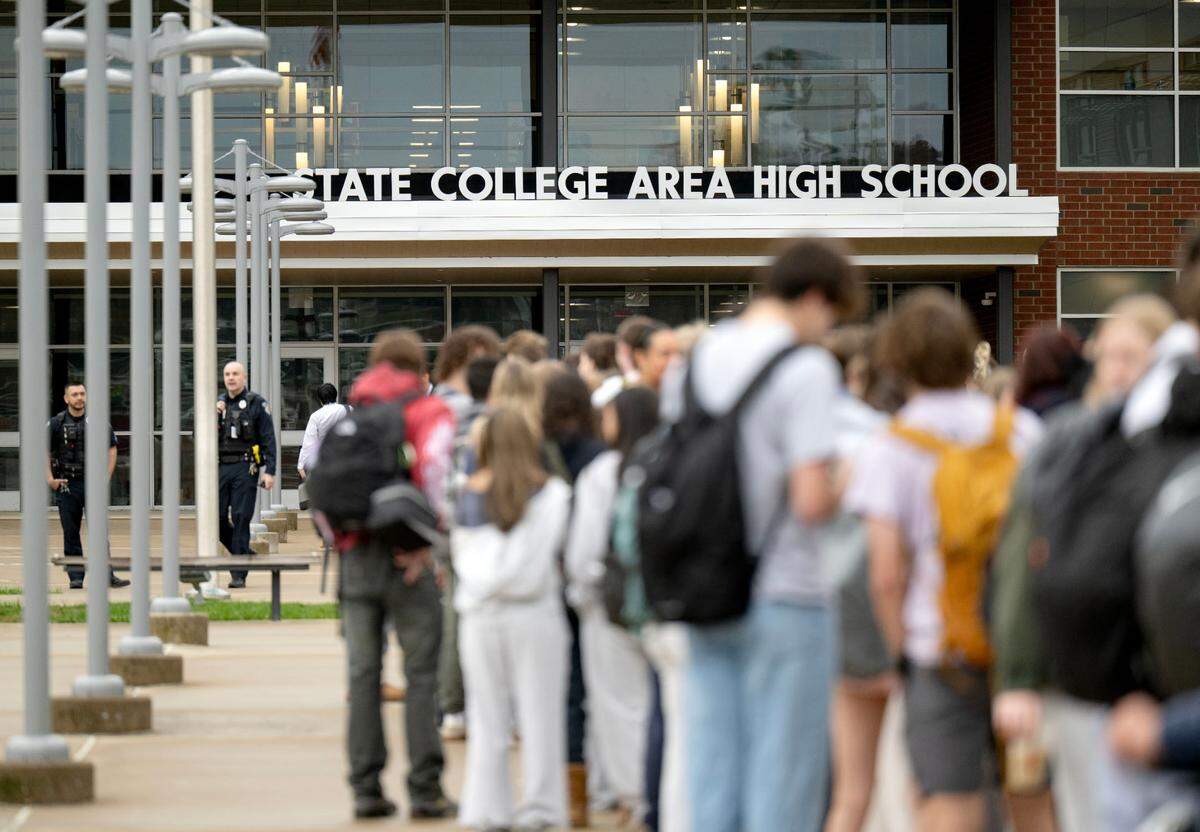 Students wait in line to enter the State College Area High School due to additional safety measures on Monday, April 14, 2025. Students had to enter through a metal detector and have their bags checked.  