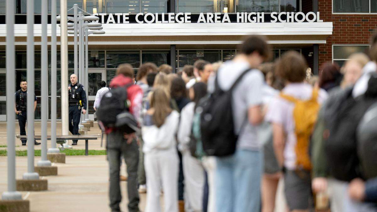 Students wait in line to enter the State College Area High School due to additional safety measures on April 14, 2025. Students had to enter through a metal detector and have their bags checked.  